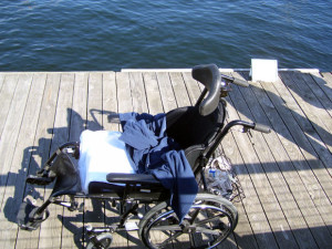 Empty wheelchair on the pier in the harbor