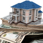 Symbolic picture of home built on money stacks